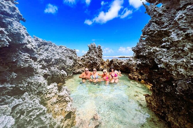 REEF ISLAND | private island | pink sand | natural swimming pools - A lunar-looking shore of black rock and pink sand